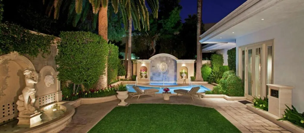 Outdoor pool and lawn area in Mirage's 3 bedroom villa
